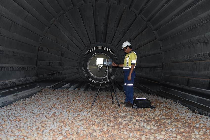 Mining engineer inside a ball mill doing measurements.