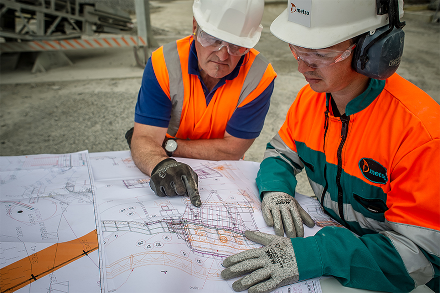 Two men in  a quarry looking at the setup plan.