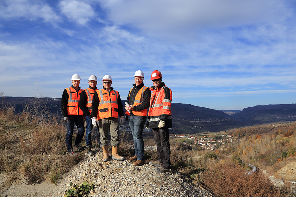 Group of people standing on a small hill at Famy's quarry in France.